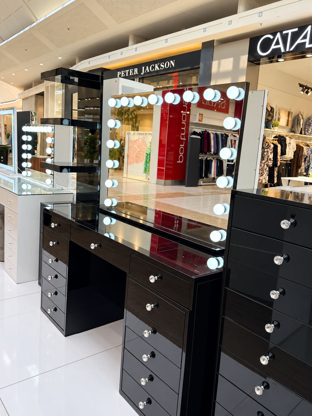 Vanity Vault's black Luna Luxe illuminated mirror displayed above a black vanity desk; furniture shown separately.
