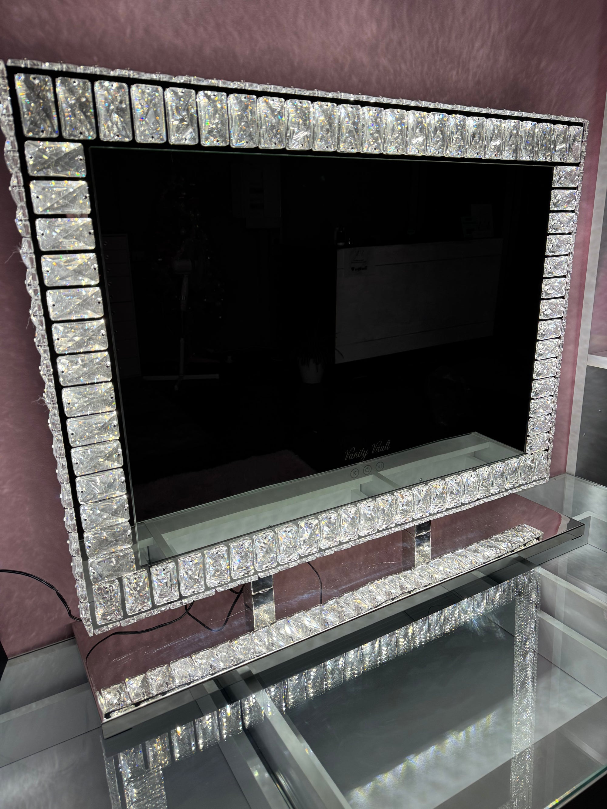 Angel Magic Diamond LED mirror with a sparkling diamond-encrusted frame, soft ambient LED lighting, dimmable brightness and three light settings for makeup vanities, bedrooms and beauty rooms by Vanity Vault.