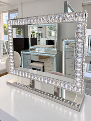 Angel Magic Diamond mirror with illuminated crystal frame and mirrored stand in the showroom
