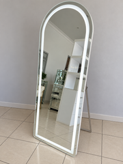 Aries Arch full-length floor mirror with illuminated LED border and freestanding support in the Vanity Vault showroom