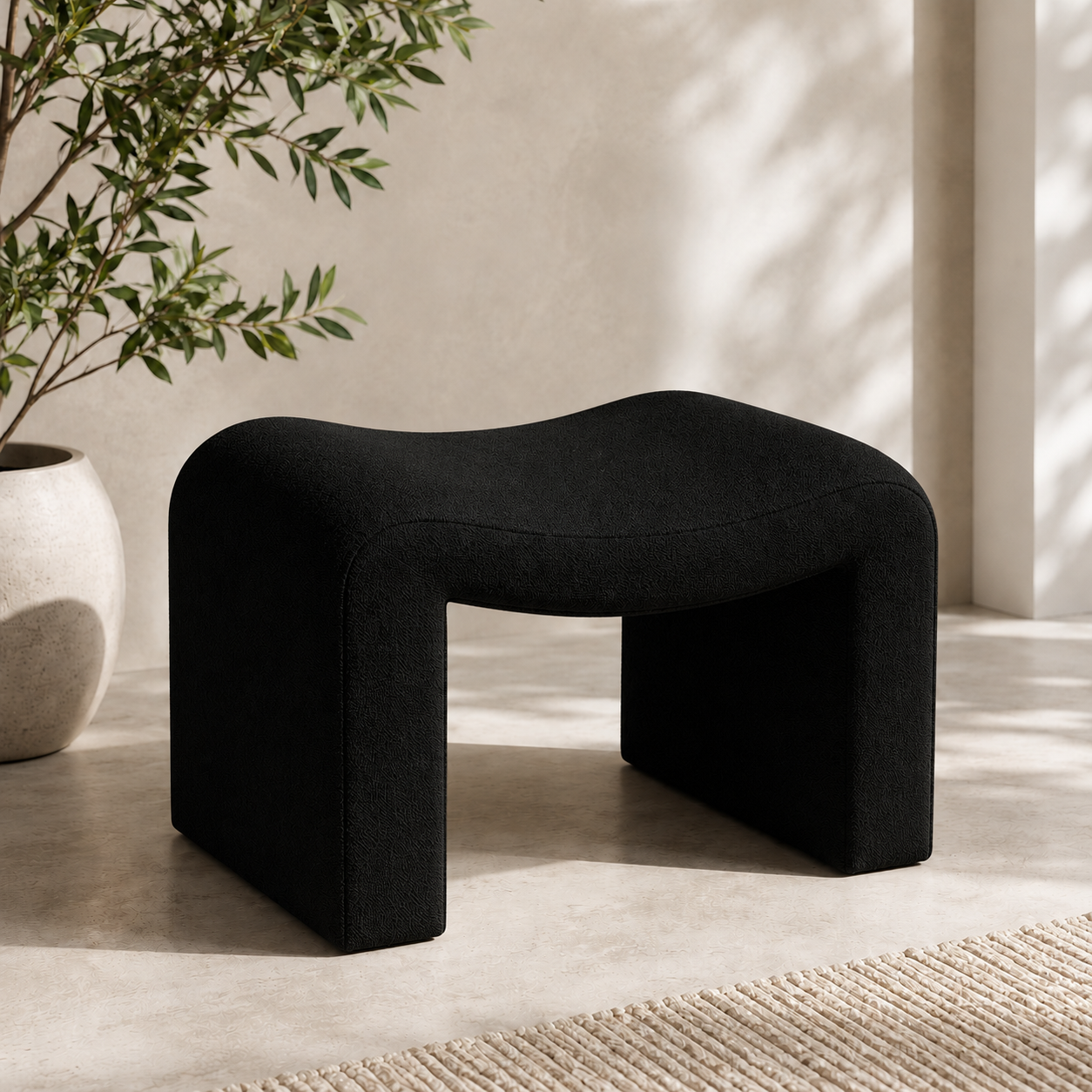 Black Willow Curve vanity stool with textured bouclé fabric and sculptural curved design for makeup desks and beauty rooms.