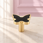 Decorative butterfly drawer knob with a textured stone-effect inlay and brushed gold frame, designed for luxury vanities, bedside tables and cabinetry