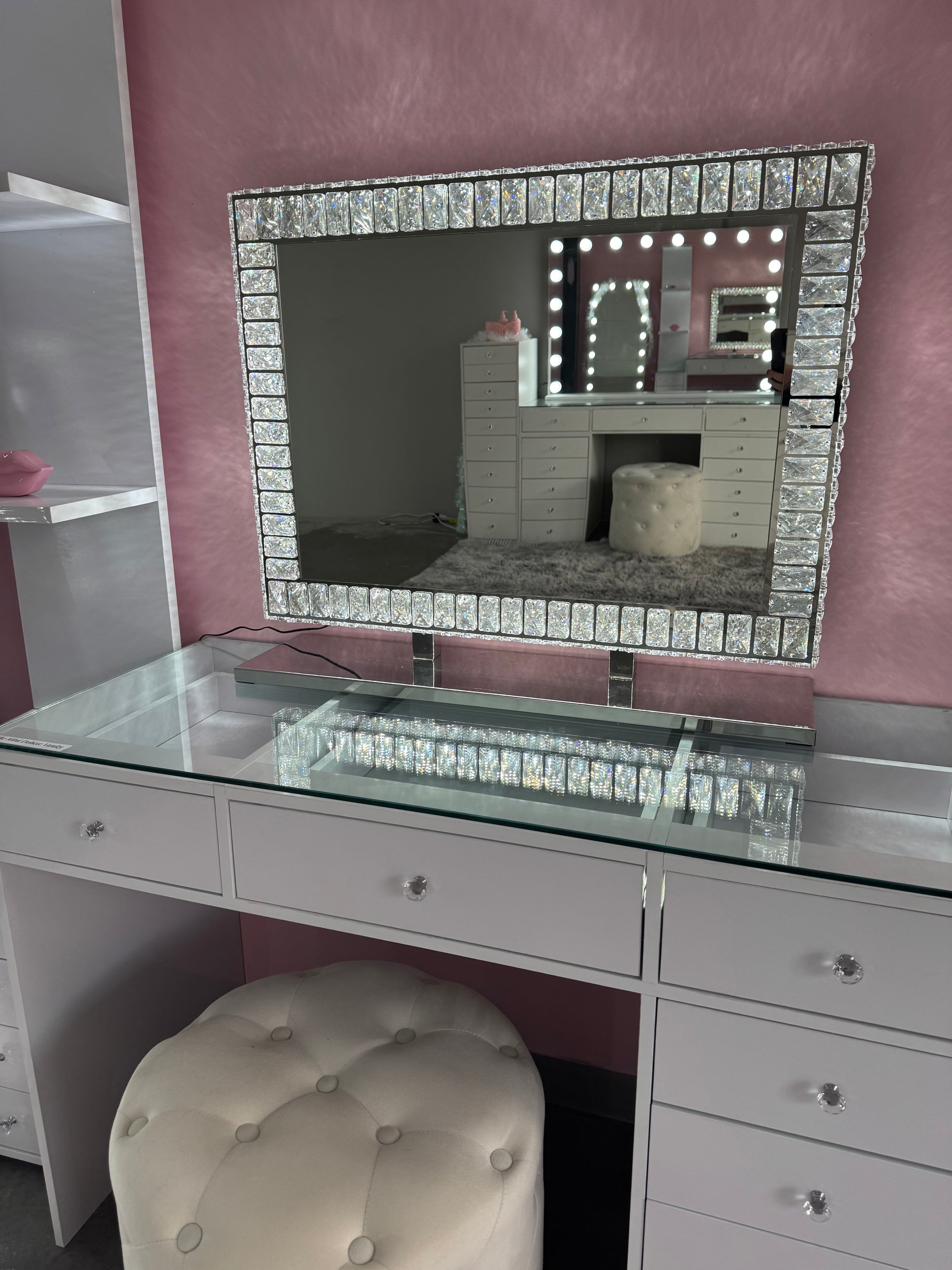Crystal vanity mirror with soft LED lighting, a sparkling diamond-encrusted frame and elegant mirrored base for makeup vanities, dressing rooms and bedrooms.