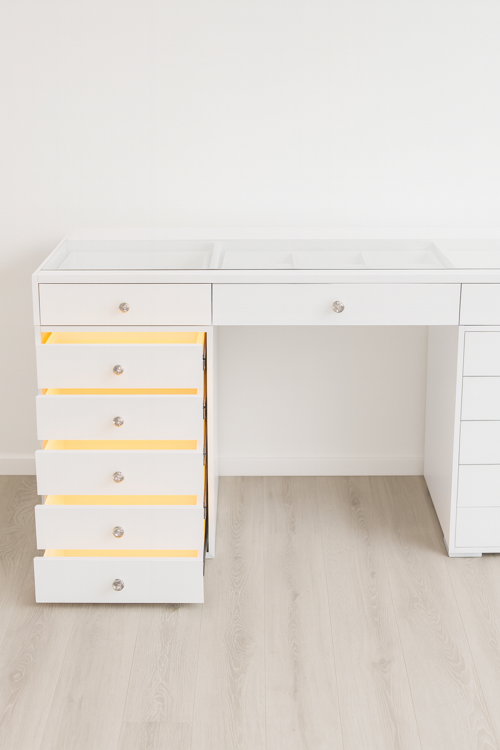 Designer Deluxe makeup vanity with LED-lit drawers, flush glass top, crystal-style knobs and a luxury high-gloss finish for elegant beauty rooms and dressing spaces.