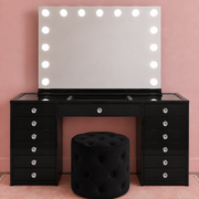 The Essentials Collection Black Edition luxury makeup vanity package with Black Out Beauty vanity, LED Hollywood mirror and matching ottoman by Vanity Vault — with clear faceted crystal drawer knobs.