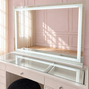 Extra-large LED makeup mirror with soft ambient strip lighting, adjustable brightness and warm, cool and neutral light settings for luxury beauty spaces.