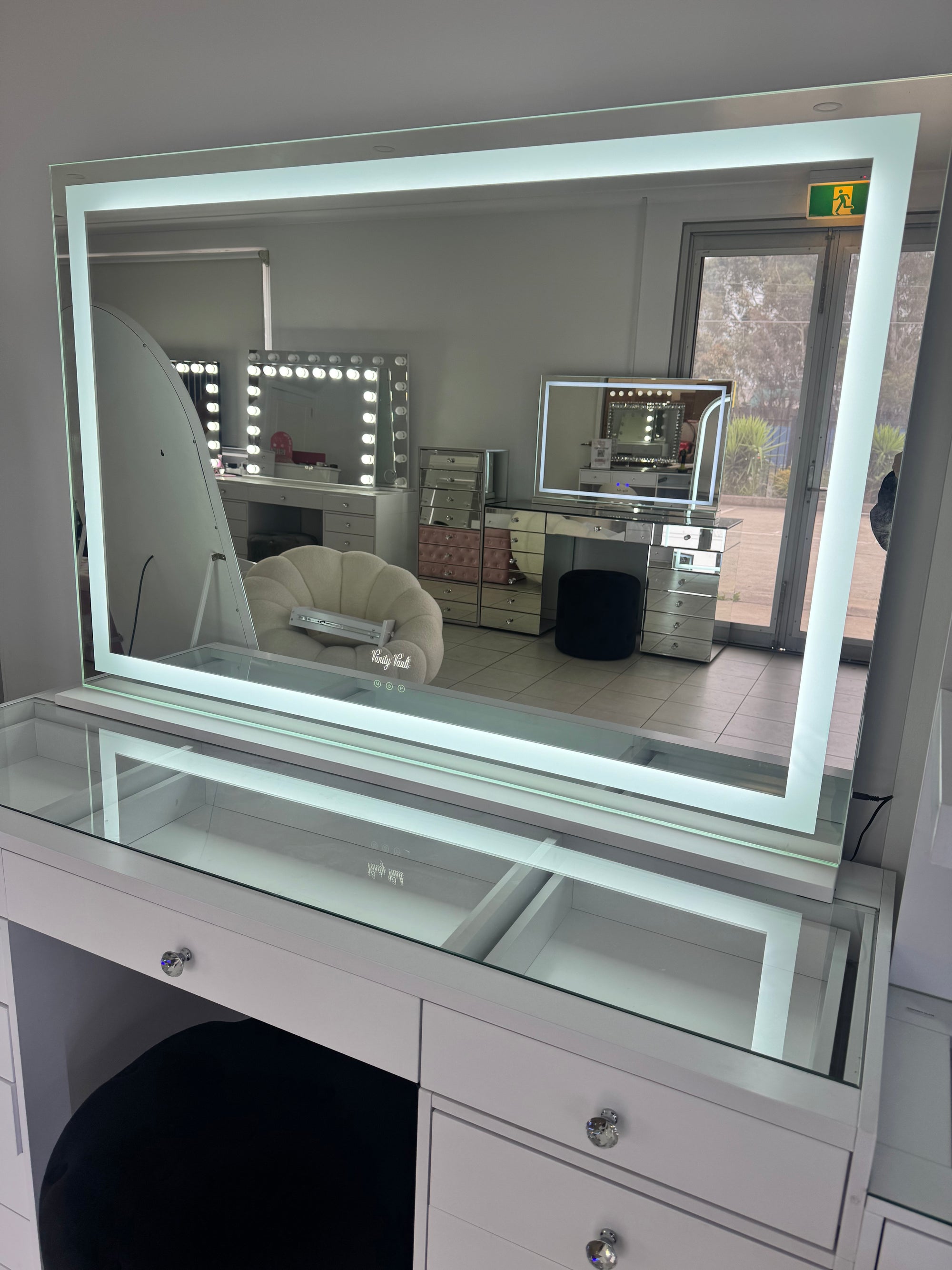 Extra-large LED makeup mirror with soft ambient strip lighting, adjustable brightness and warm, cool and neutral light settings for luxury beauty spaces.
