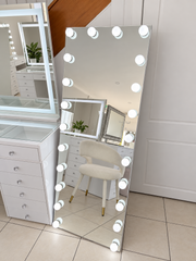 Glamour Glow full-length floor mirror with illuminated round LED bulbs in the Vanity Vault showroom