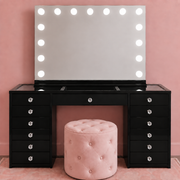 Luxury black vanity package with Hollywood LED mirror, glass top makeup desk and upholstered ottoman, perfect for bedrooms, salons and beauty spaces — with clear faceted crystal drawer knobs.