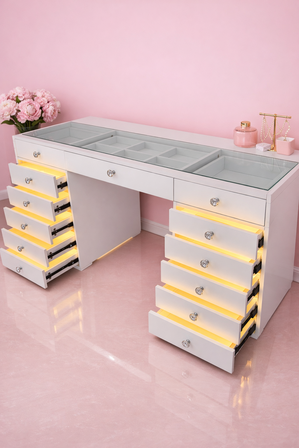 Luxury dressing table with a flush glass top, LED-lit drawers, spacious storage and a premium high-gloss finish for glamorous beauty spaces.
