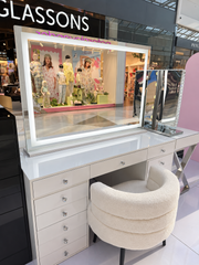 Nova XL illuminated mirror on a Babyface vanity with solid white top and crystal knobs, paired with the white Sweet Sundae Lounge Seat