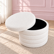 Vanilla Swirl white round ottoman with its lid lifted to show the black-lined storage compartment.