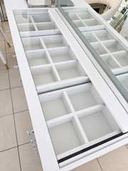 Overhead view of flush-fitted glass within the white desktop frame, with drawer organisers beneath