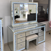 Winter Whisper three-piece vanity set with illuminated crystal-trim mirror, mirrored desk and matching upholstered stool in the showroom